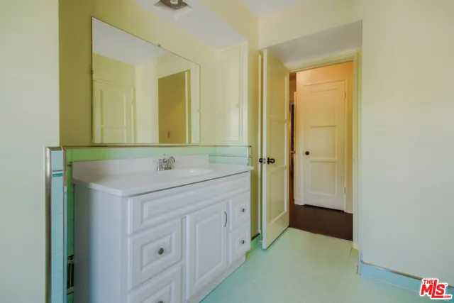 a bathroom with a sink a mirror and a shower