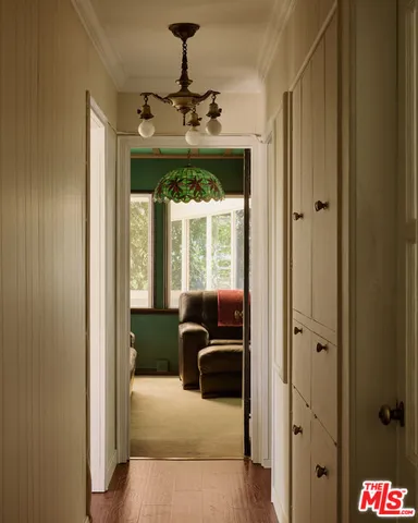 a hallway with furniture and a chandelier
