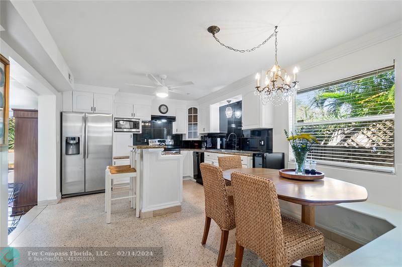 321 Forsyth Street Boca Raton, FL 33487 - Photo 5 of 22 a dining room with furniture a chandelier and kitchen view