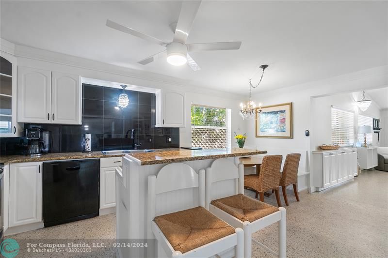321 Forsyth Street Boca Raton, FL 33487 - Photo 8 of 22 a kitchen with cabinets a sink and chairs in it
