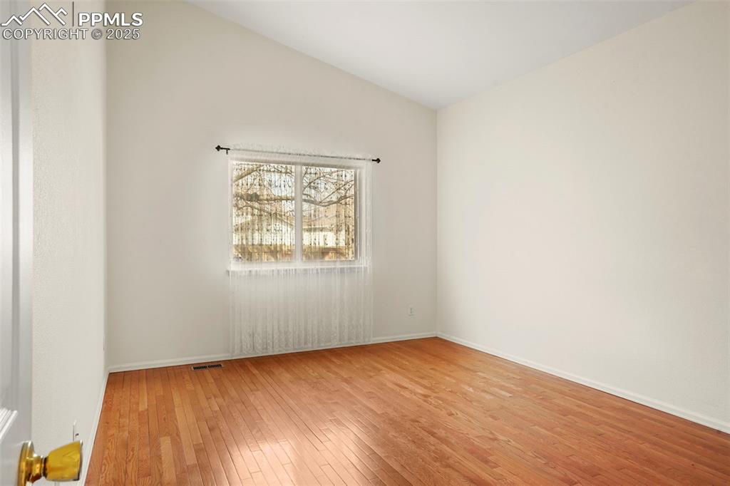 1244 Samuel Point Colorado Springs, CO 80906 - Photo 12 of 22 an empty room with wooden floor and windows