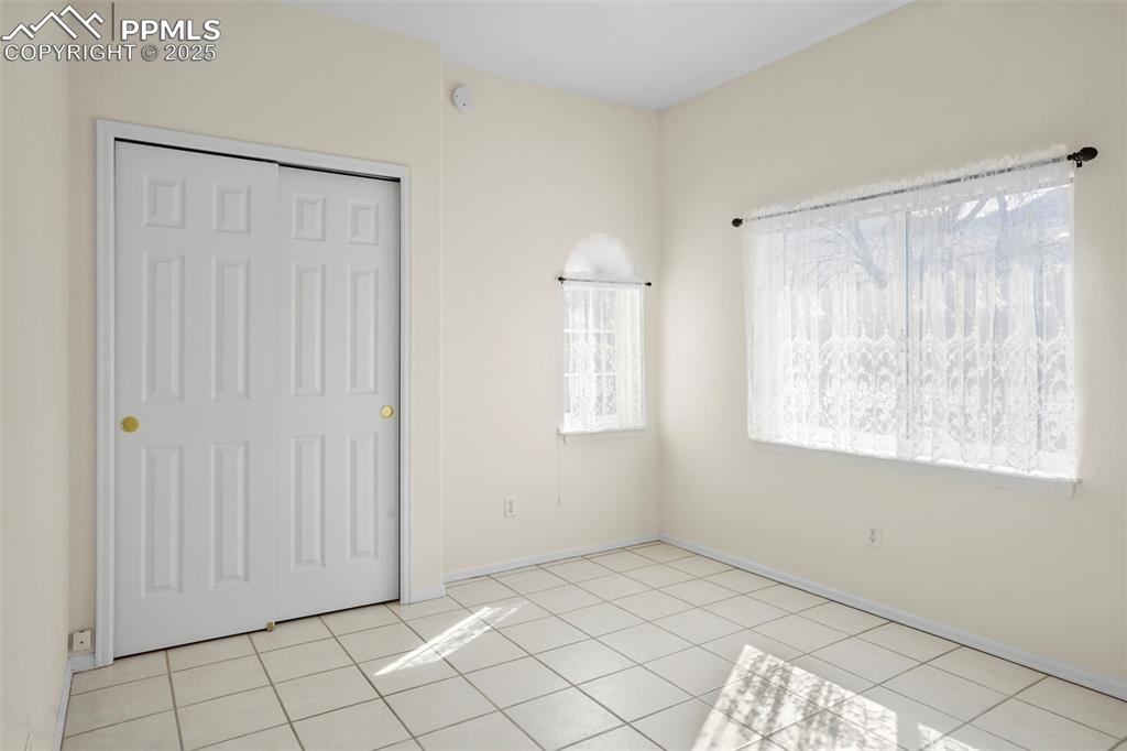 1244 Samuel Point Colorado Springs, CO 80906 - Photo 19 of 22 a view of an empty room with window and cabinet area