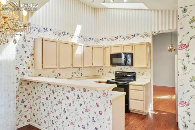 a kitchen with granite countertop a sink and a stove