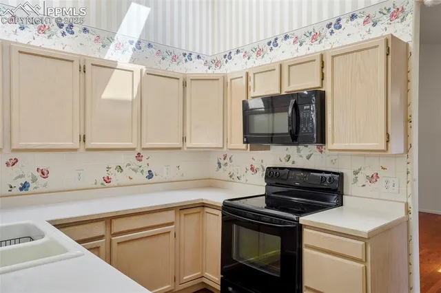 a kitchen with stainless steel appliances a sink a stove and a microwave