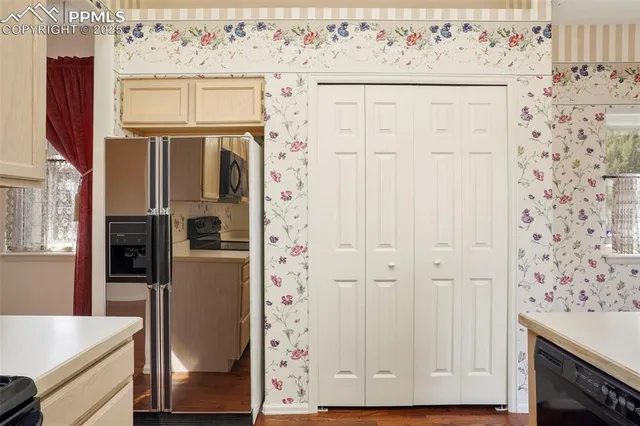 a view of bathroom with a refrigerator washer and dryer