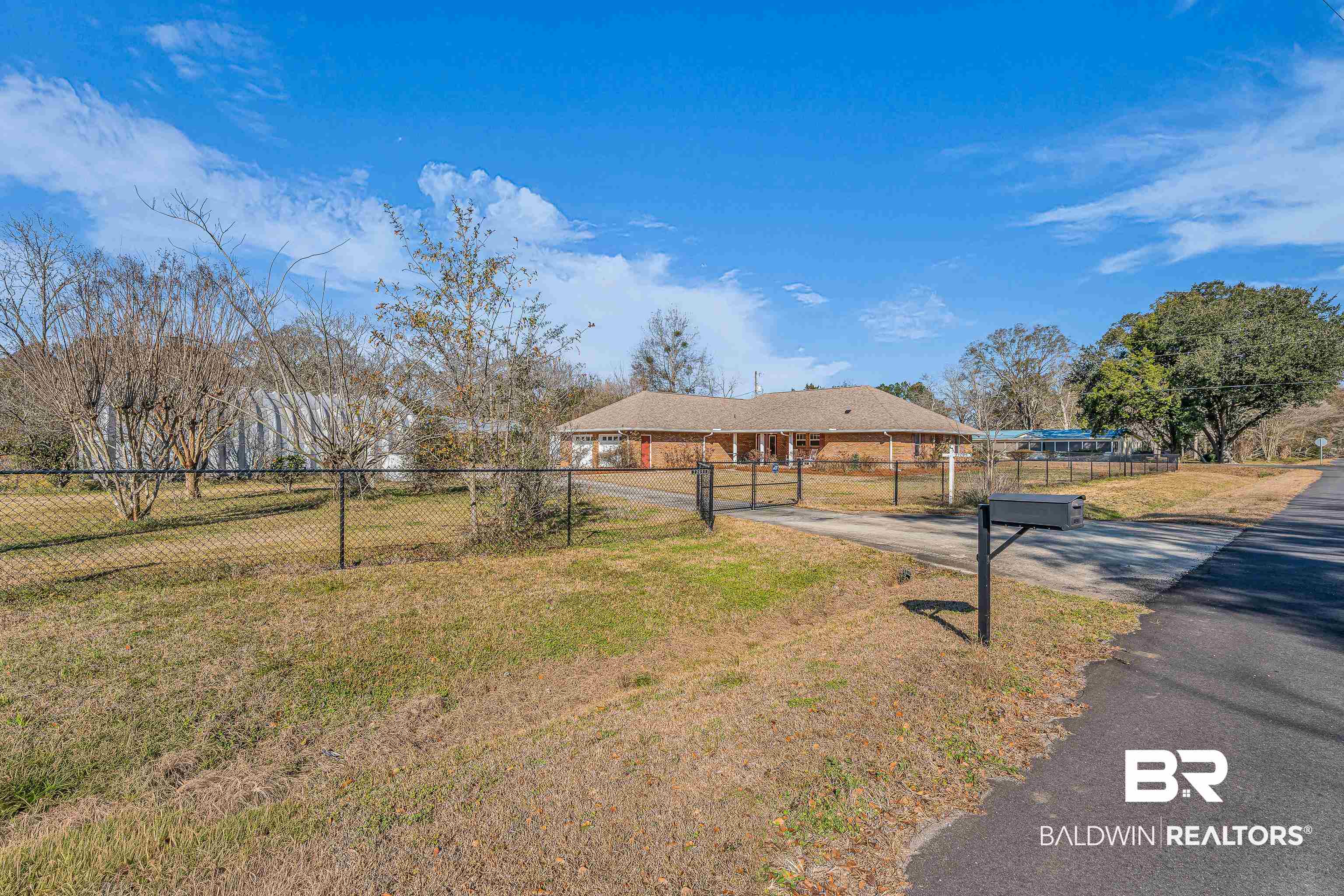 22095 8th Street Silverhill, AL 36576 - Photo 6 of 42 View of front of property with a gate, asphalt driveway, and a carport