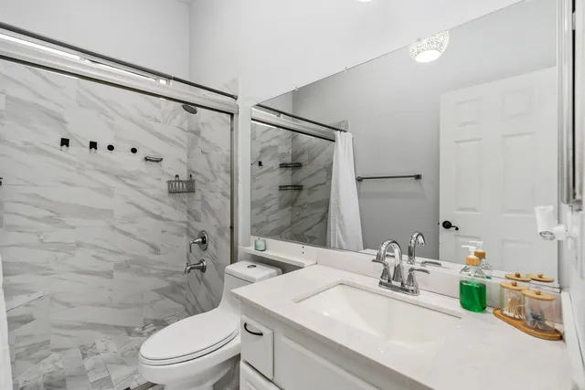 a bathroom with a sink toilet and shower