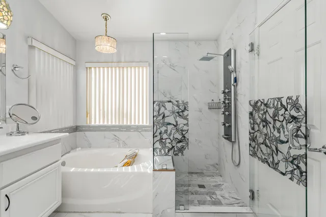 a bathroom with a bathtub sink and shower