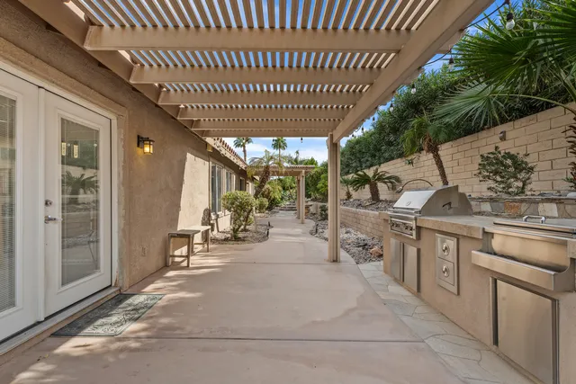 a view of a patio with table and chairs and potted plants