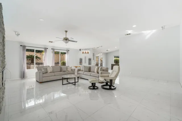 a living room with furniture and white walls