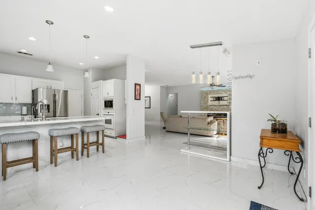 a living room with furniture and kitchen view