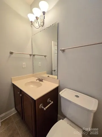 a bathroom with a sink a toilet and mirror