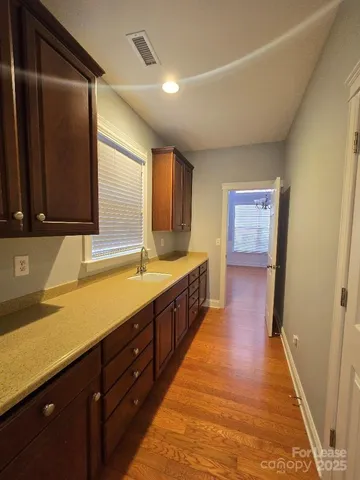 a spacious bathroom with a sink and a large mirror