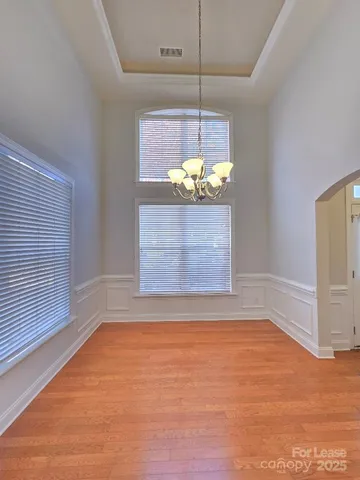 a view of room with window and chandelier