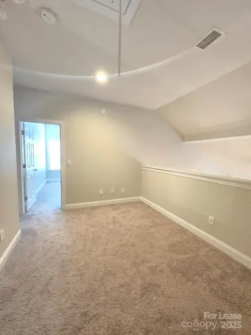 en empty room with windows and entrance