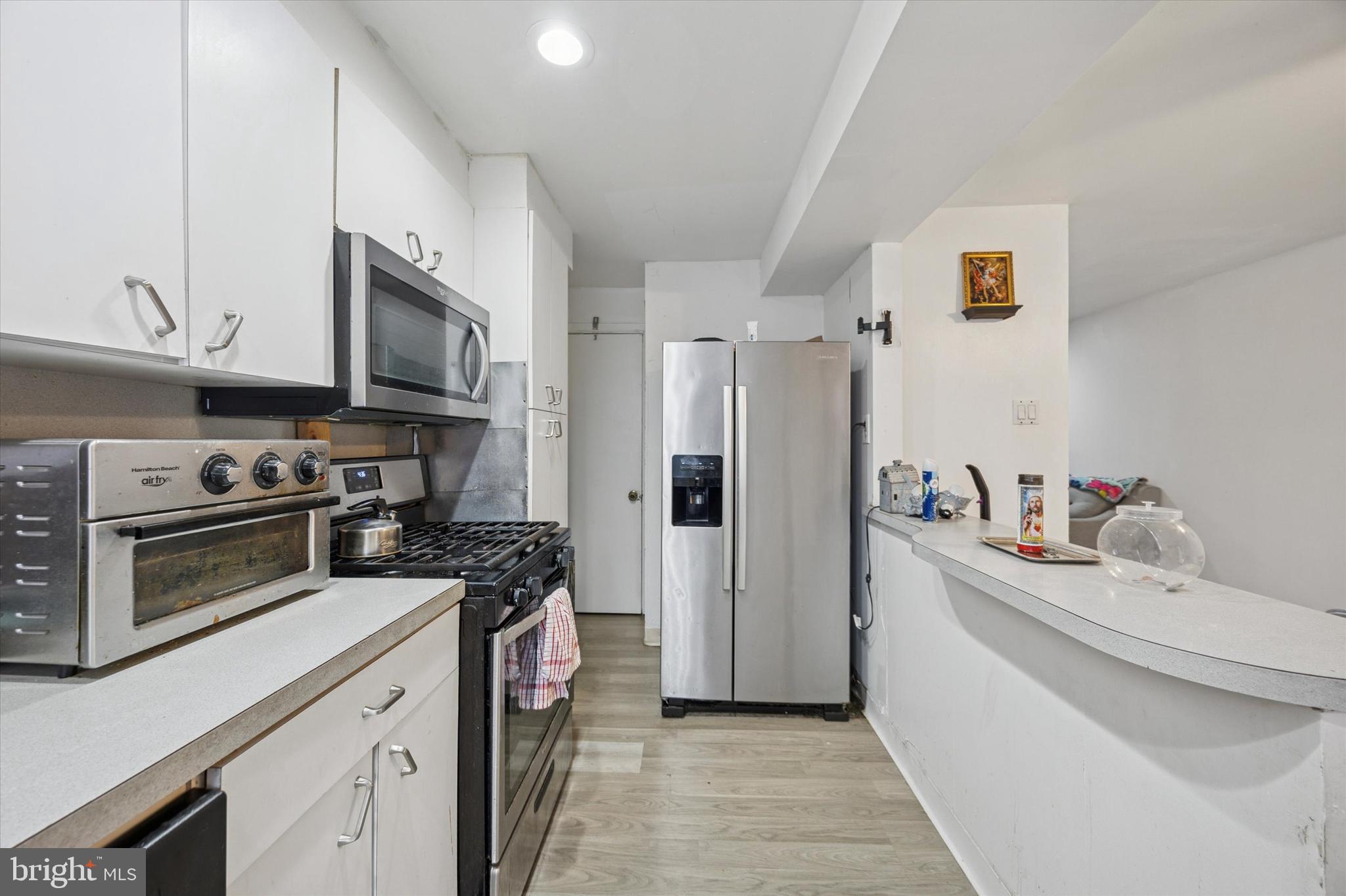 1946 Carter Road Folcroft, PA 19032 - Photo 6 of 26 a kitchen with stainless steel appliances a stove a sink a refrigerator and cabinets