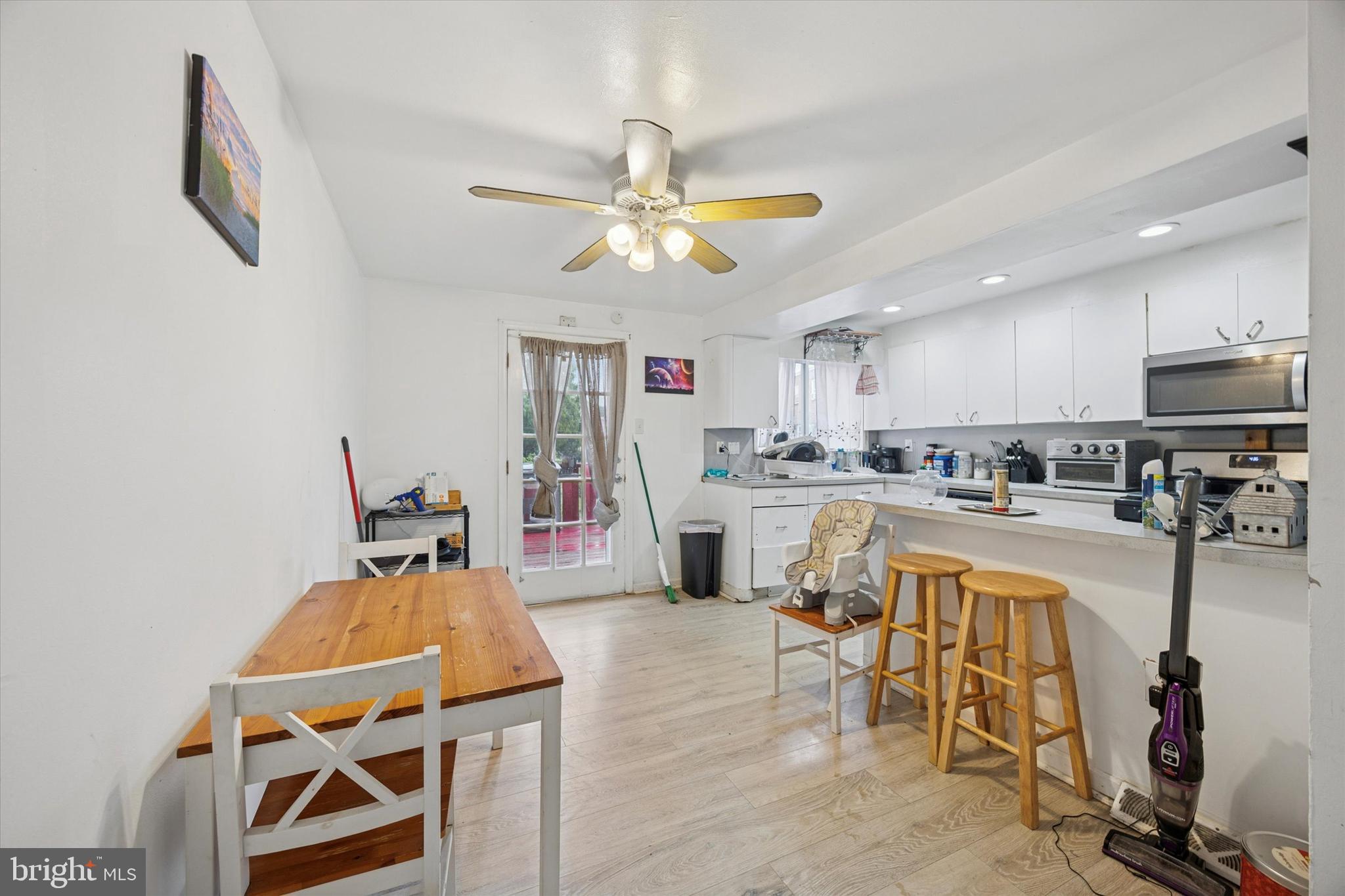 1946 Carter Road Folcroft, PA 19032 - Photo 9 of 26 a living room with furniture a flat screen tv and kitchen view