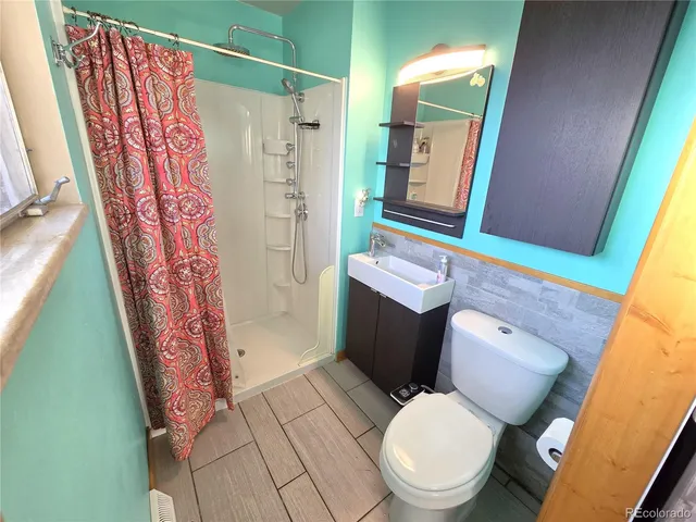 a room with wooden floor and a window