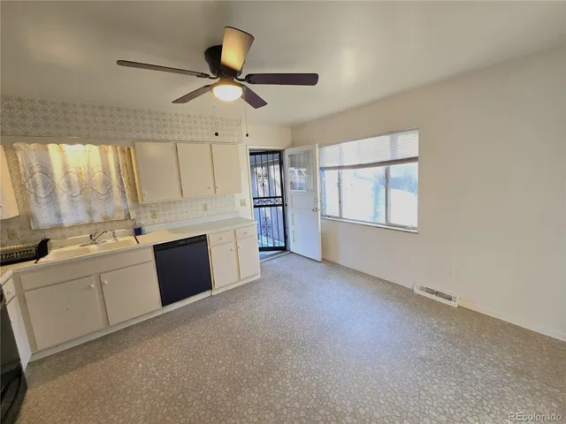 a view of a kitchen with a sink and a refrigerator