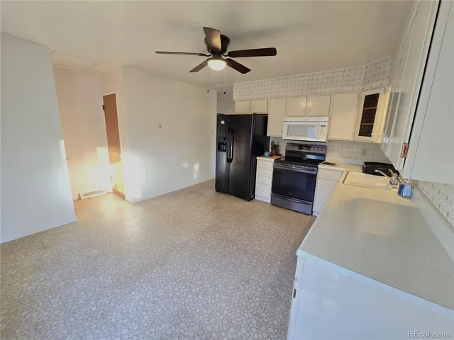 a view of empty room with wooden floor and fireplace
