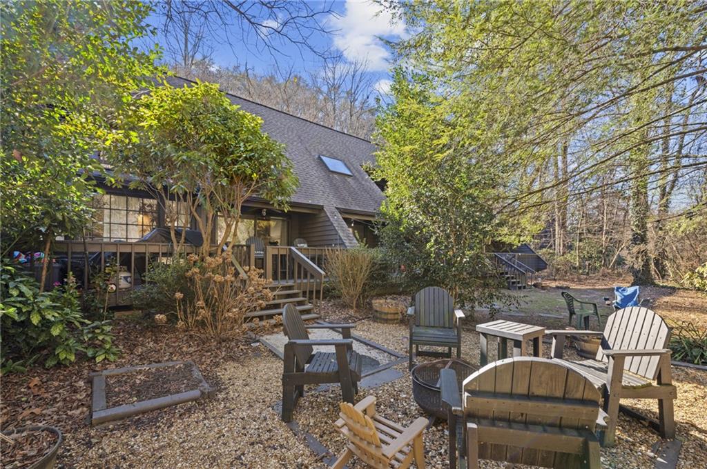 a backyard of a house with table and chairs
