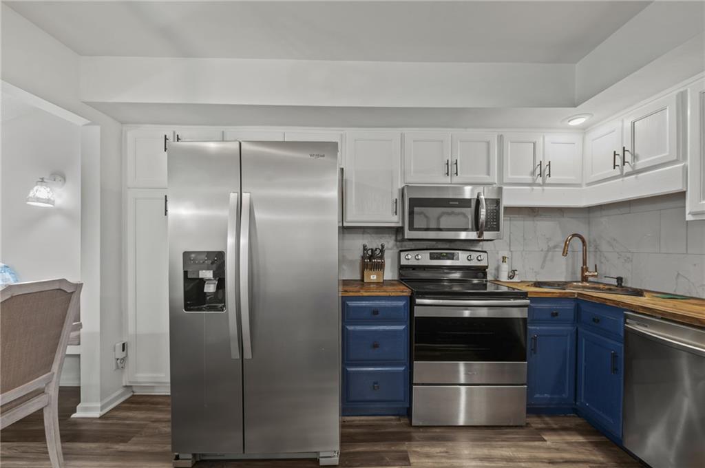 655 Riverside Drive Ellijay, GA 30540 - Photo 16 of 34 a kitchen with stainless steel appliances granite countertop a sink stove and refrigerator