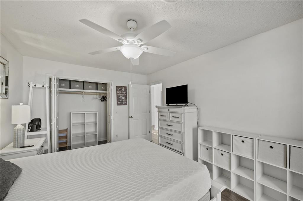 655 Riverside Drive Ellijay, GA 30540 - Photo 20 of 34 a bedroom with a bed and a flat tv screen on dresser