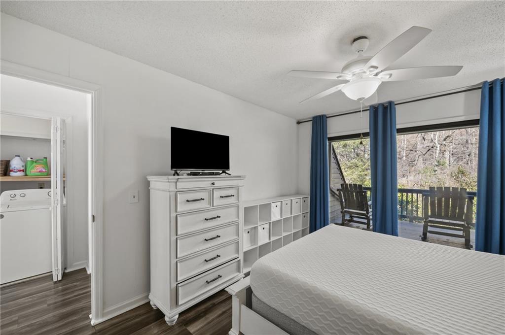 655 Riverside Drive Ellijay, GA 30540 - Photo 24 of 34 a bedroom with a large bed and a flat tv screen on dresser