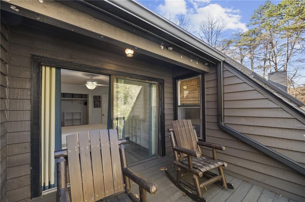 655 Riverside Drive Ellijay, GA 30540 - Photo 26 of 34 a view of a balcony with chair and front door