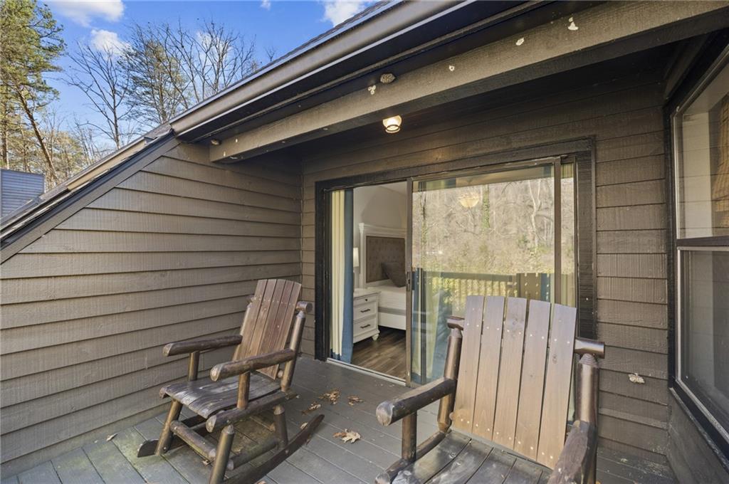 655 Riverside Drive Ellijay, GA 30540 - Photo 27 of 34 a roof deck with table and chairs and potted plants