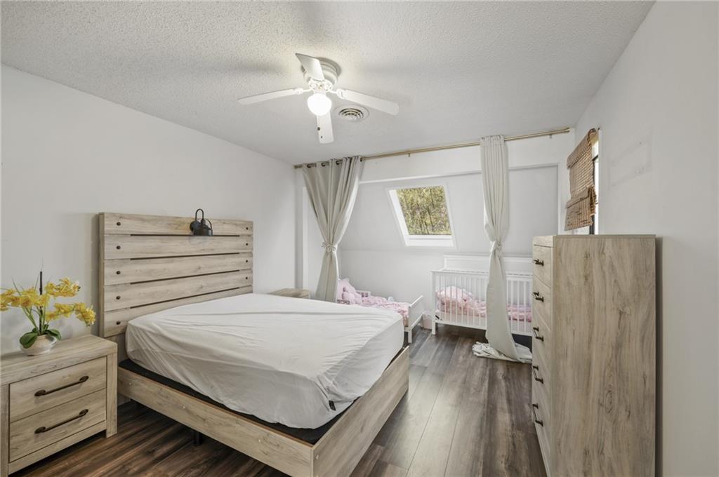 655 Riverside Drive Ellijay, GA 30540 - Photo 30 of 34 a bedroom with a bed and a chandelier