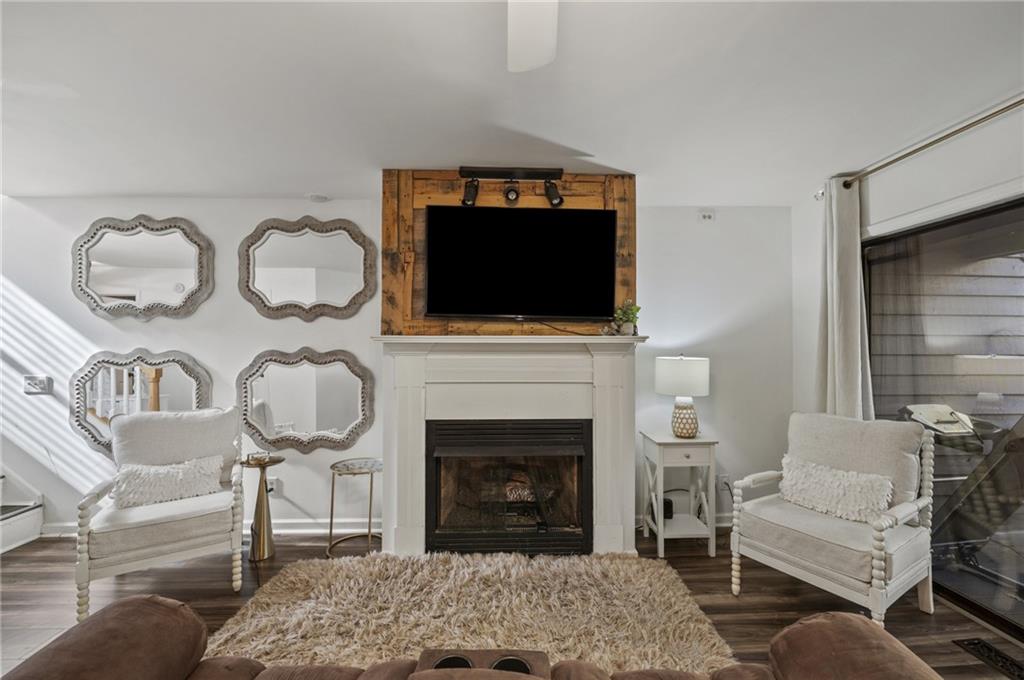 655 Riverside Drive Ellijay, GA 30540 - Photo 8 of 34 a living room with furniture a flat screen tv and a fireplace