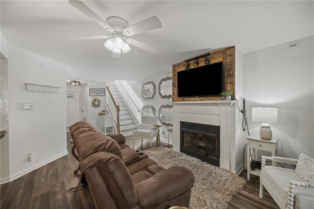 655 Riverside Drive Ellijay, GA 30540 - Photo 10 of 34 a living room with furniture a flat screen tv and a fireplace