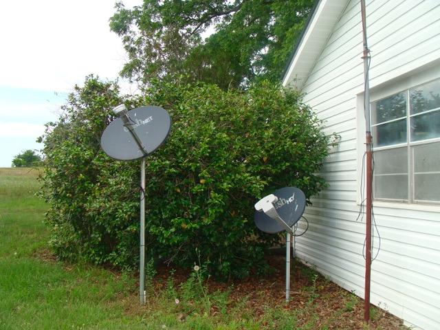 592 Mims Road DeFuniak Springs, FL 32433 - Photo 32 of 67 a view of a chair and fire pit in the backyard of a house