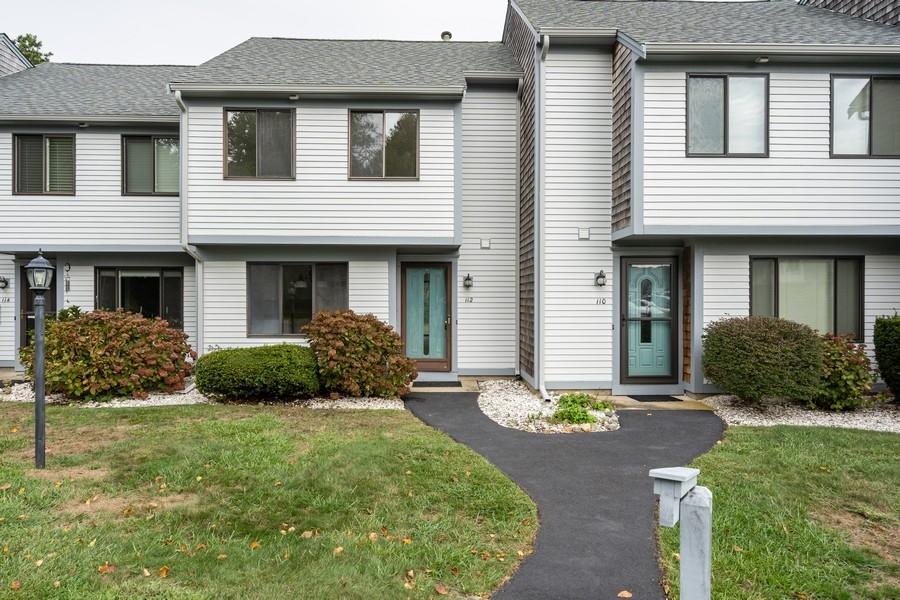 112 Chestnut Circle Brewster, MA 02631 - Photo 1 of 15 a front view of a house with a yard