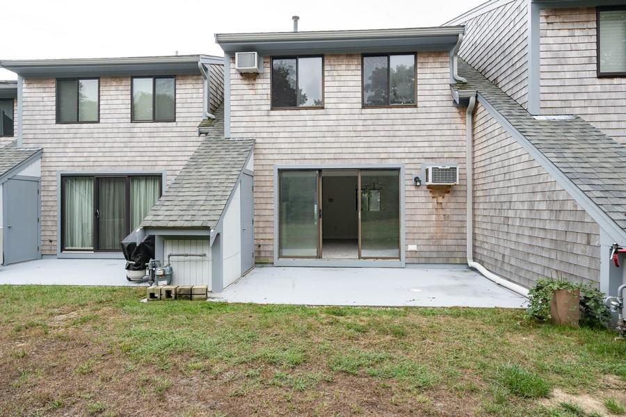 112 Chestnut Circle Brewster, MA 02631 - Photo 14 of 15 a front view of a house with a yard