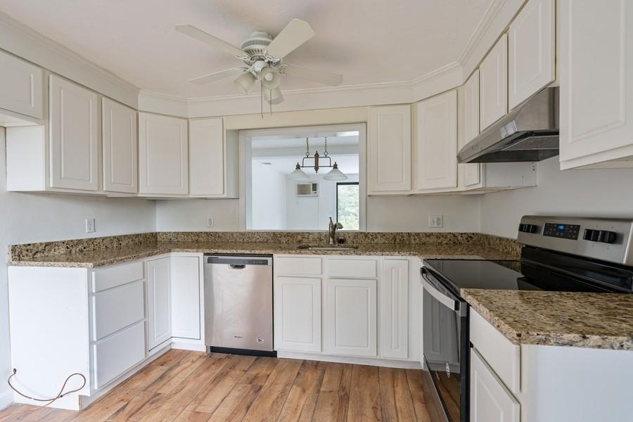 112 Chestnut Circle Brewster, MA 02631 - Photo 2 of 15 a kitchen with stainless steel appliances granite countertop a sink stove and cabinets