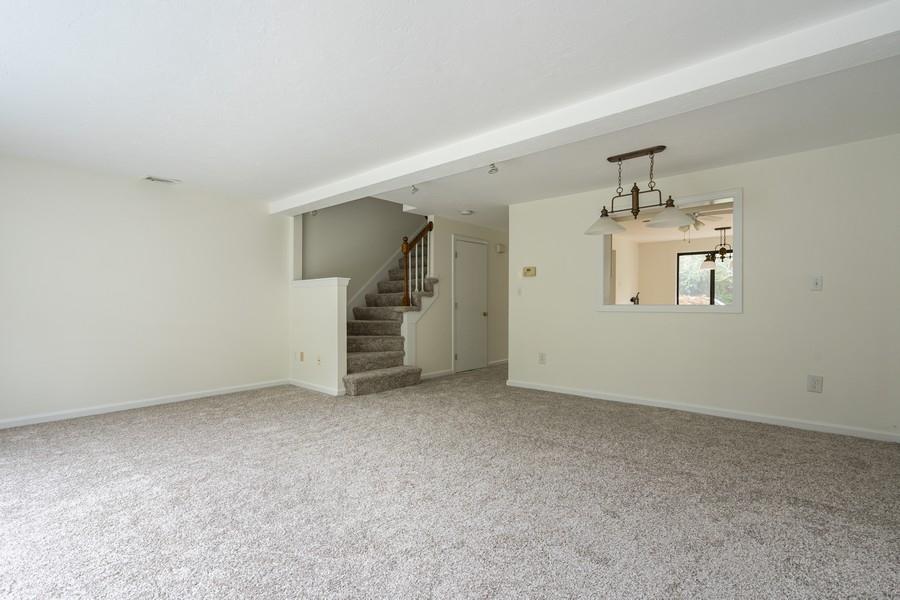 112 Chestnut Circle Brewster, MA 02631 - Photo 5 of 15 an empty room with chandelier fan and windows