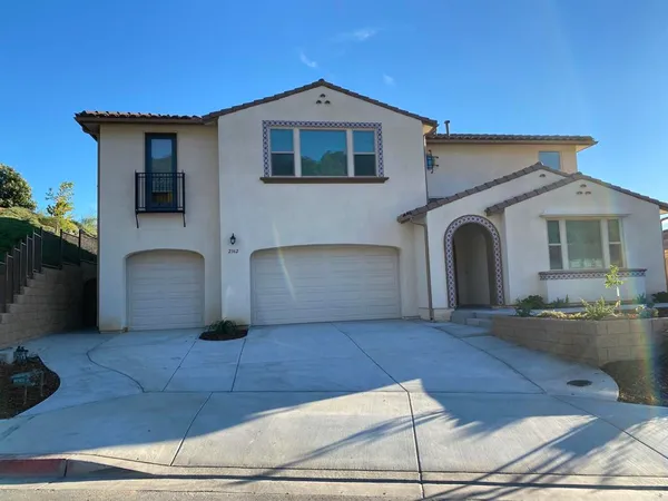 a front view of a house with yard