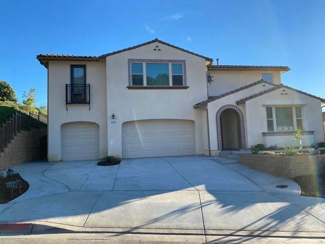 a front view of a house with yard