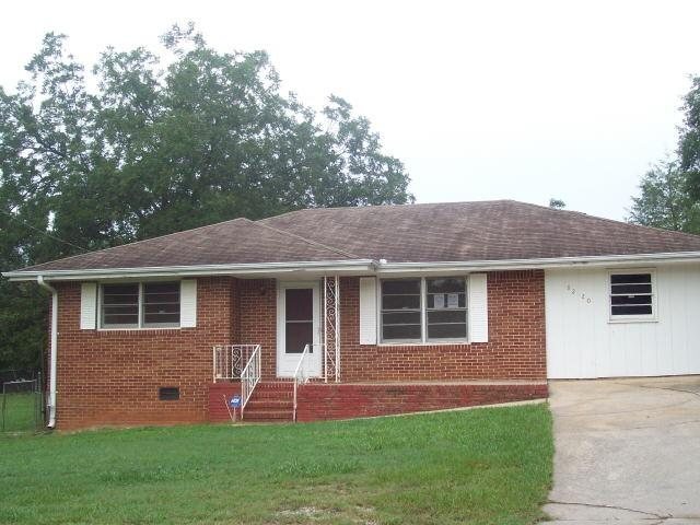 8220 Flat Shoals Road Southwest Covington, GA 30014 - Photo 1 of 1 a front view of a house with a yard and green space