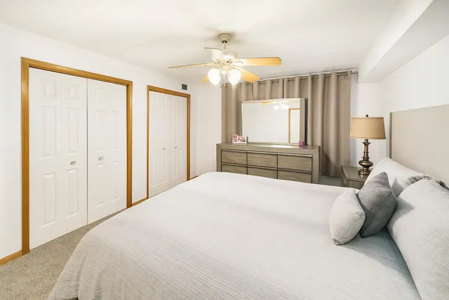 a bedroom with a large bed and a chandelier