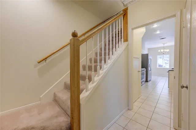 a view of staircase with white walls and railing
