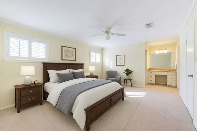 a spacious bedroom with a bed and a chandelier