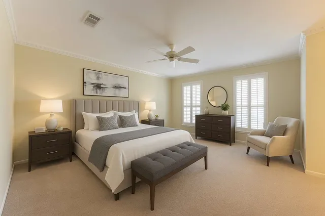 a bedroom with a bed couch and window