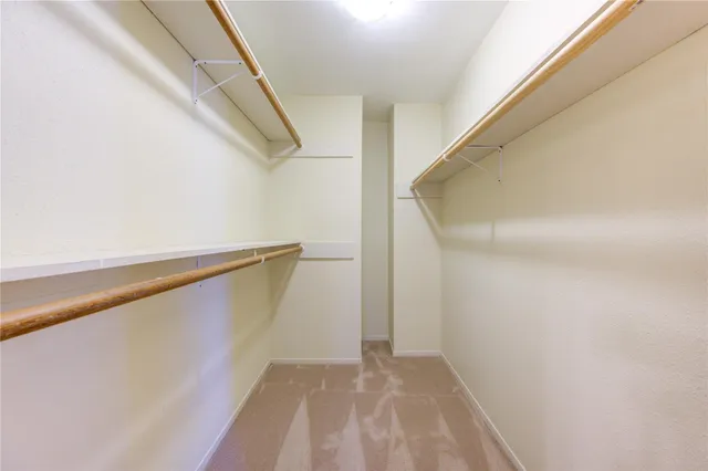 a view of staircase with railing and white walls