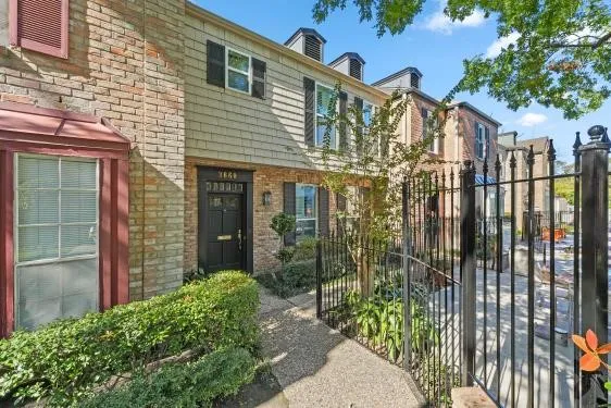 a view of a house with brick walls
