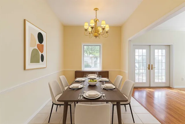 a view of a dining room with furniture wooden floor and chandelier