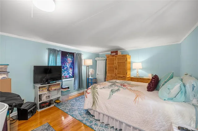 a bedroom with a bed and a flat screen tv