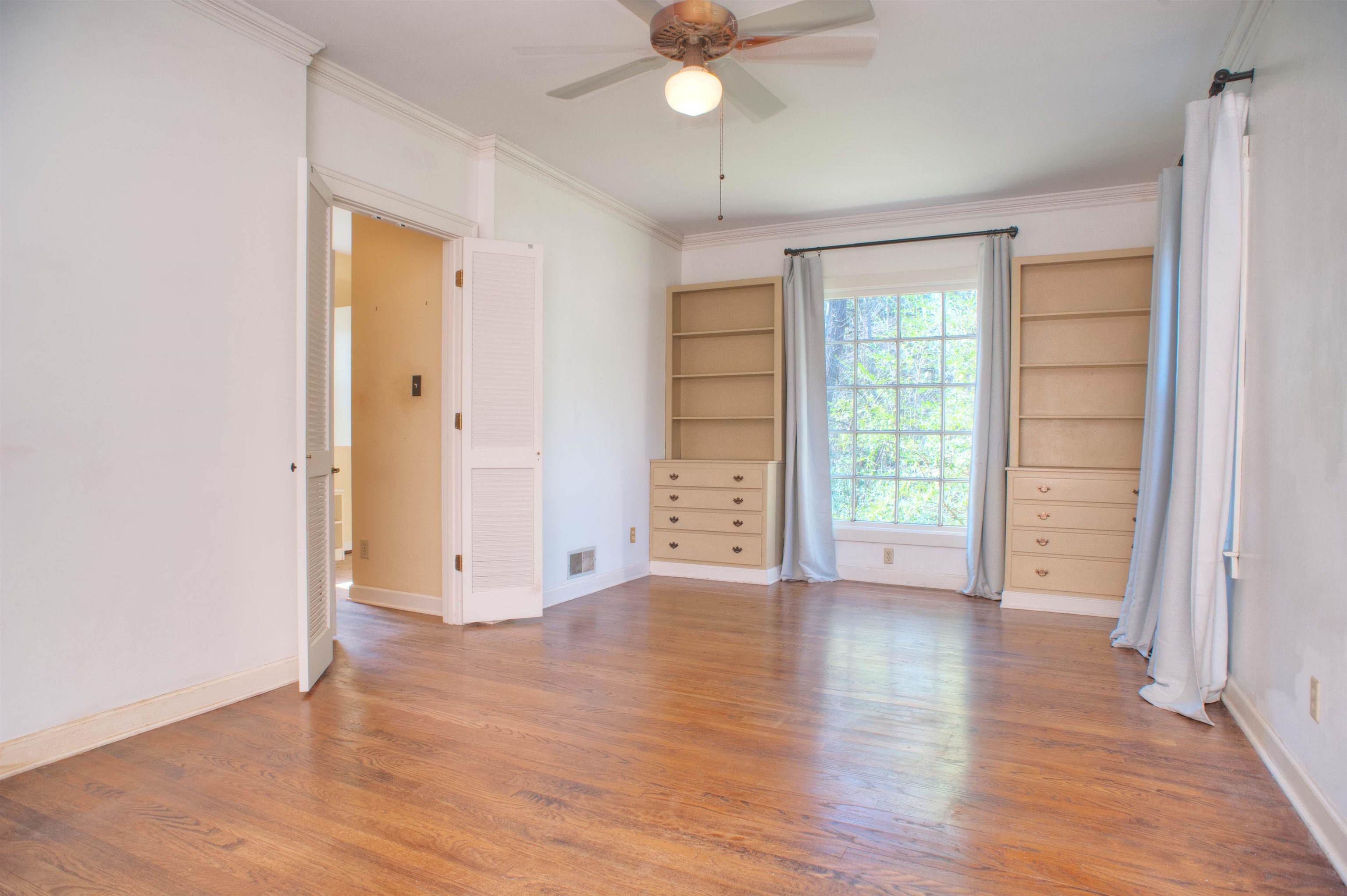 4756 Princeton Road Memphis, TN 38117 - Photo 12 of 22 an empty room with wooden floor cabinet and windows